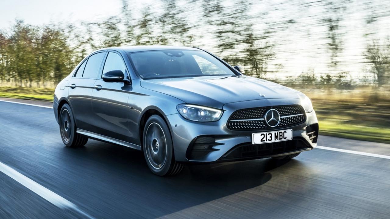 Silver Mercedes-Benz E-Class driving in the countryside