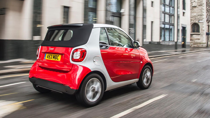Red Smart ForTwo, rear shot, driving
