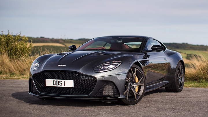 Grey Aston Martin DBS, parked in countryside