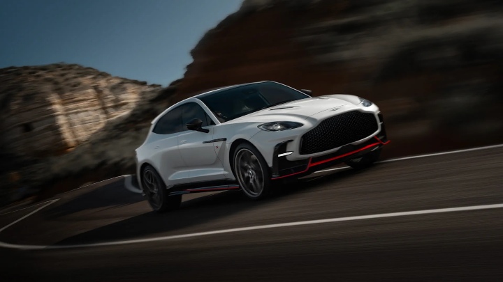 White Aston Martin DBX S driving along mountain road