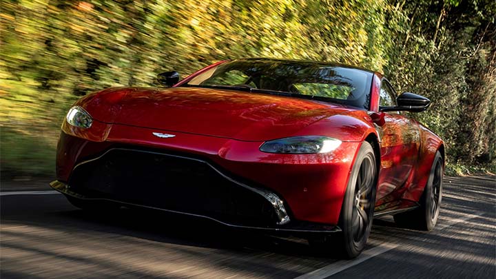 Red Aston Martin Vantage, driving in the countryside