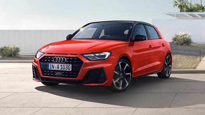 Red Audi A1 Sportback front quarter shot, parked in front of a white wall