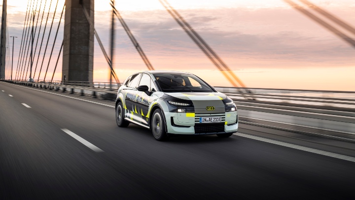 Audi A2 e-tron driving sunset
