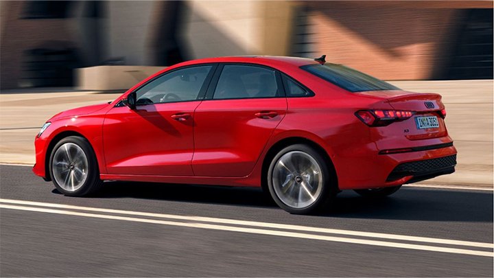 Rear quarter driving shot of a red Audi A3 Saloon