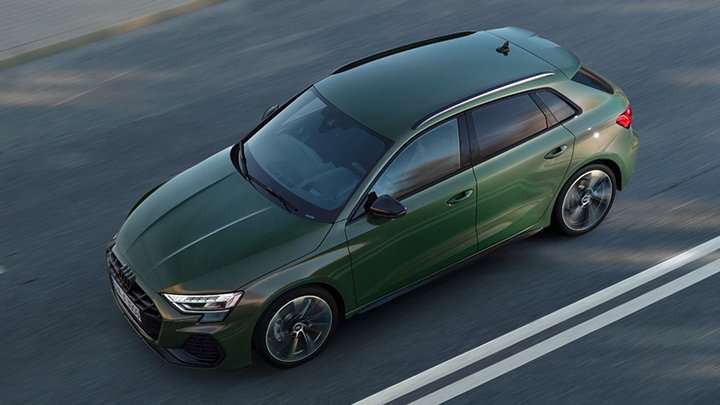 Aerial shot of a green Audi A3 Sportback driving down a road