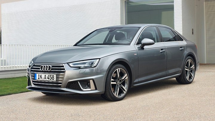 Front static shot of a silver Audi A4 Saloon parked in front of a house
