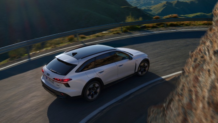 Audi A6 Allroad hybrid electric driving on mountain road