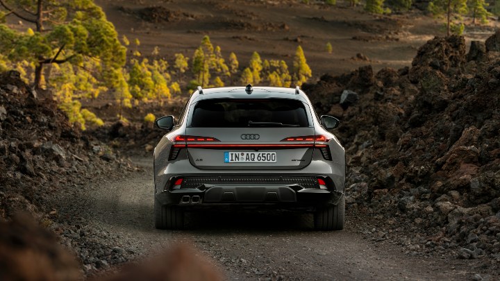 Audi A6 allroad quattro driving along a rocky off-road trail surrounded by rugged terrain