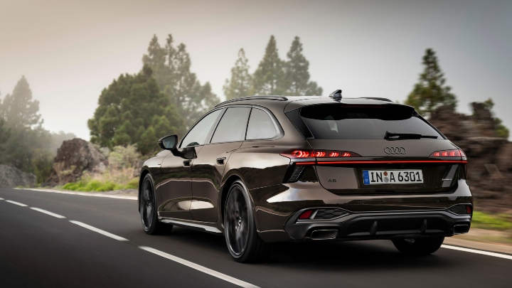 Audi A6 Avant Dark Brown rear angle driving