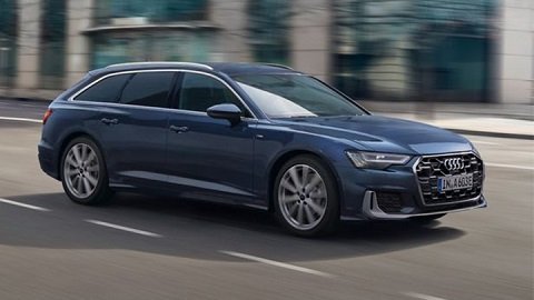 Front quarter driving shot of a blue Audi A6 Avant