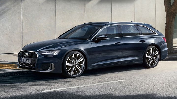 Front left quarter shot of a blue Audi A6 Avant that's parked at the side of a road