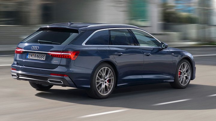 Rear quarter shot of a blue Audi A6 Avant driving down a road