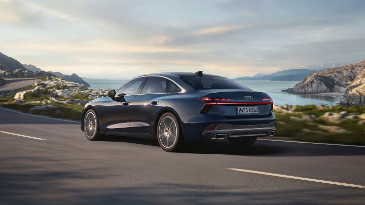 Dark Blue Audi A6 Saloon Rear driving coastal road