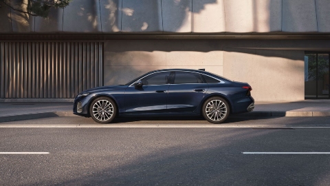 Dark Blue Audi A6 Saloon side view city street