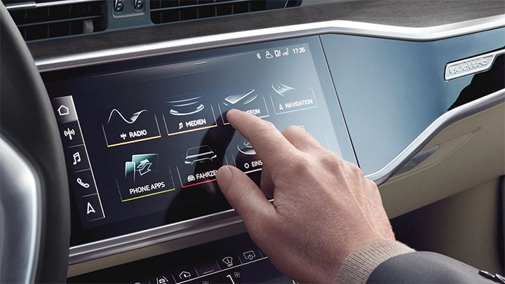Close up of a hand interacting with the infotainment system on an Audi A6 Saloon