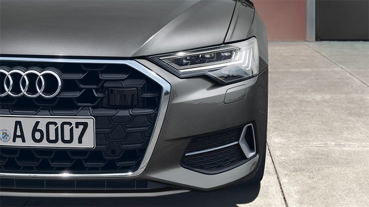 Close up of an Audi A6 Saloon's front light and grille