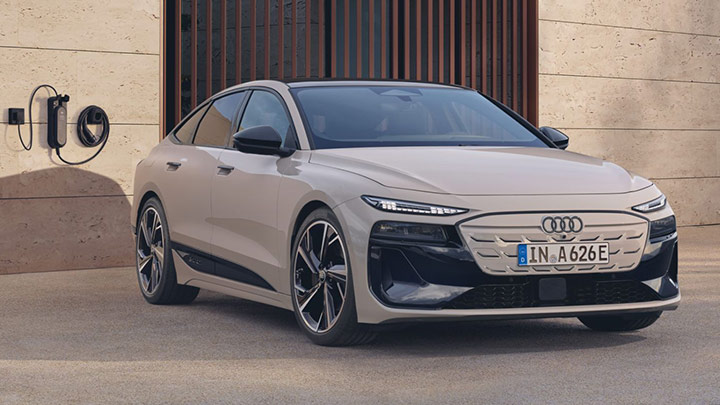 Front shot of a silver Audi A6 Sportback e-tron parked next to a charging point