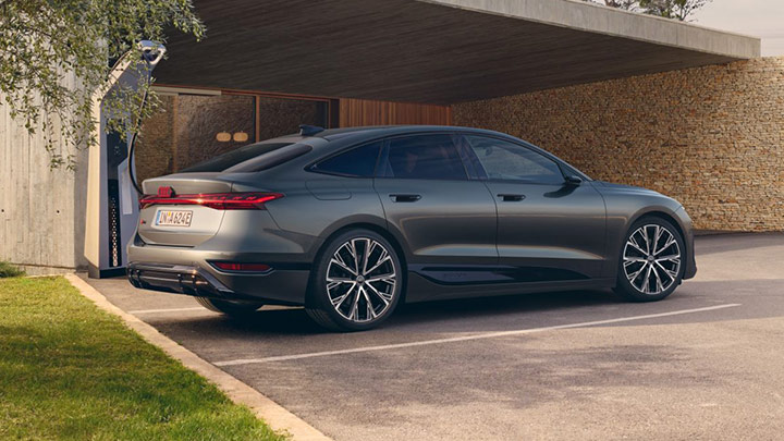 Rear quarter shot of a grey Audi A6 Sportback e-tron parked next to charging point