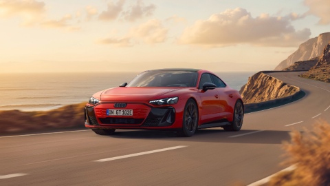 Red Audi e-tron GT Quattro driving front coastal road