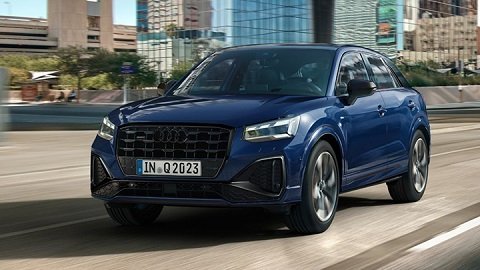 Front quarter shot of a blue Audi Q2 driving in a city