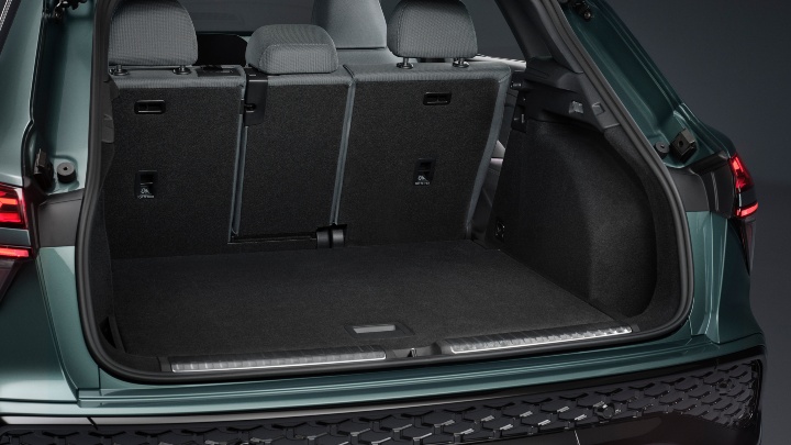 Green Audi Q3 SUV rear angle boot open
