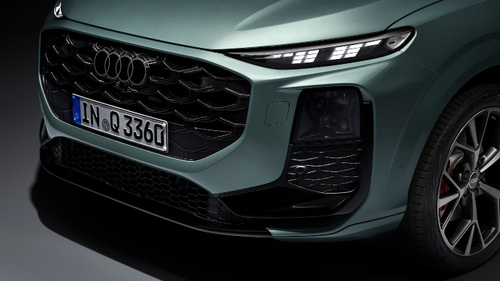 Green Audi Q3 SUV front right close up
