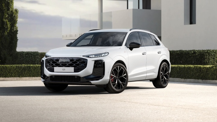 White Audi Q3 SUV Edition 1 trim level modern house background