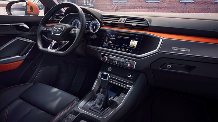 Close up of an Audi Q3's interior, including the steering wheel and centre console
