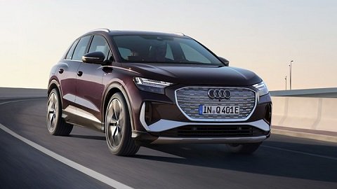 Front quarter shot of a purple Audi Q4 e-tron driving down a highway