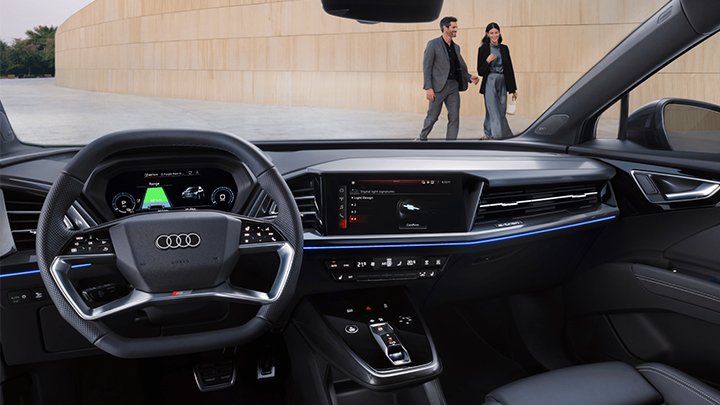 Interior shot of an Audi Q4 e-tron with two people walking in the background