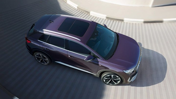 Aerial shot of a purple Audi Q4 e-tron driving up a multi-storey car park