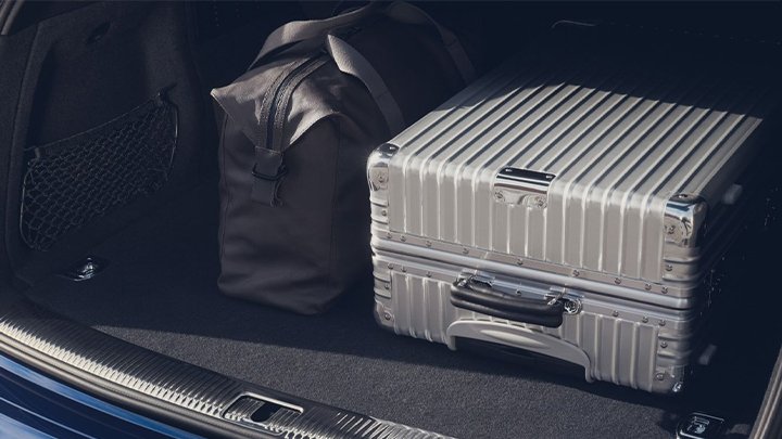 Close up of an Audi Q5 Sportback's boot, filled with a duffle bag and silver crate