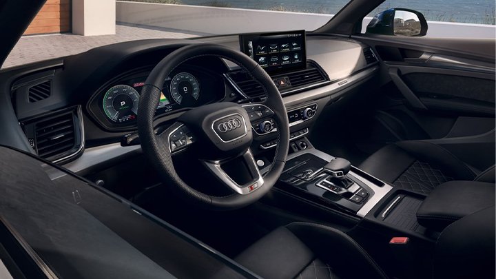 Close up of an Audi Q5 Sportback's interior, including the steering wheel and centre console