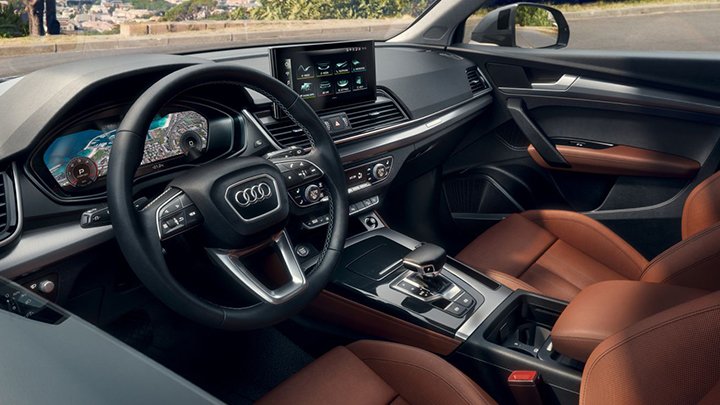 Close up of an Audi Q5's interior, including the steering wheel and centre console