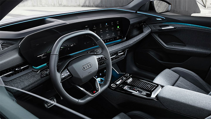 Close up of an Audi Q6 e-tron's interior, including the steering wheel and centre console