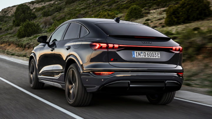 Audi Q6 Sportback e-tron Driving in Dark Grey Rear Angle