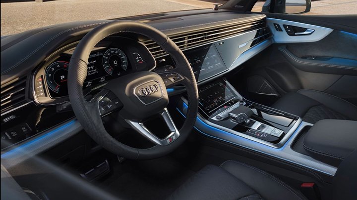 Close up of an Audi Q7's interior, including the steering wheel and centre console