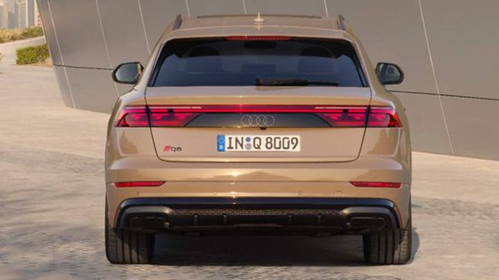 Rear shot of a beige Audi Q8 parked at sunset