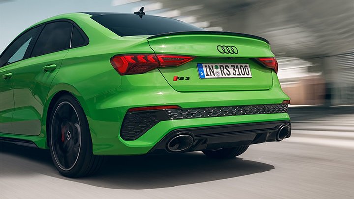 Close up of a green Audi RS 3 Saloon's rear bumper and tail lights