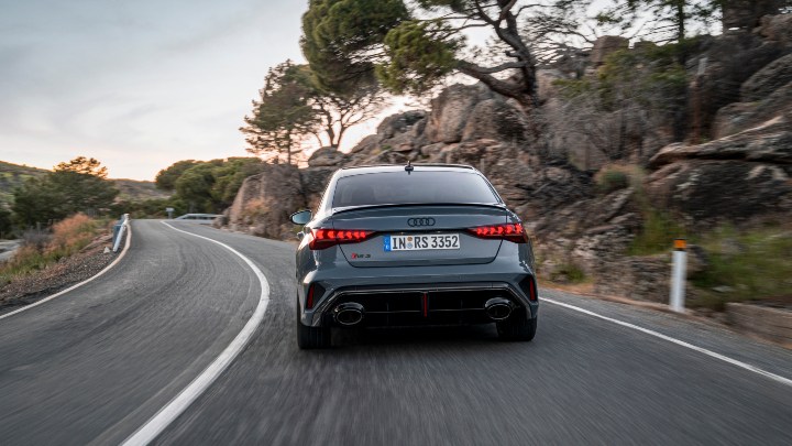 Rear view of an Audi RS 3 Saloon driving on a winding mountain road