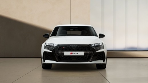 Front view of a white Audi RS 3 Sportback highlighting its distinctive RS honeycomb grille