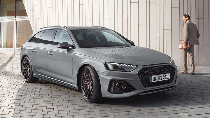 Front quarter shot of a grey Audi RS 4 Avant with a young man walking past