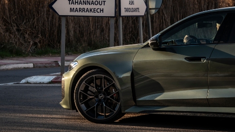 Audi RS 5 Green driving at junction