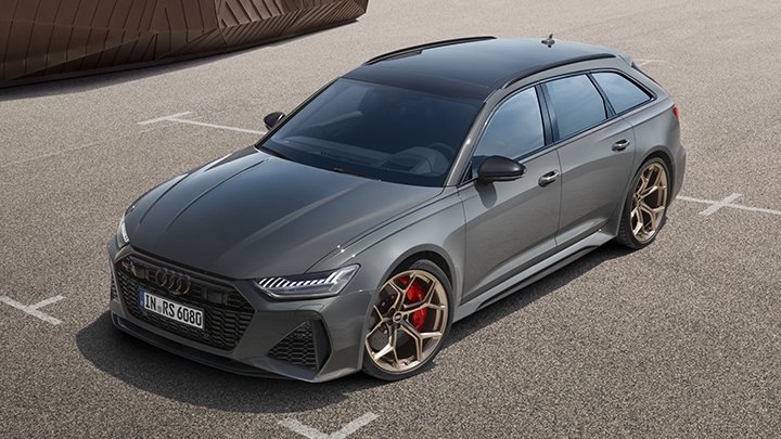 Side of a grey RS6 Avant parked within the lines of a parking spot in a car park 