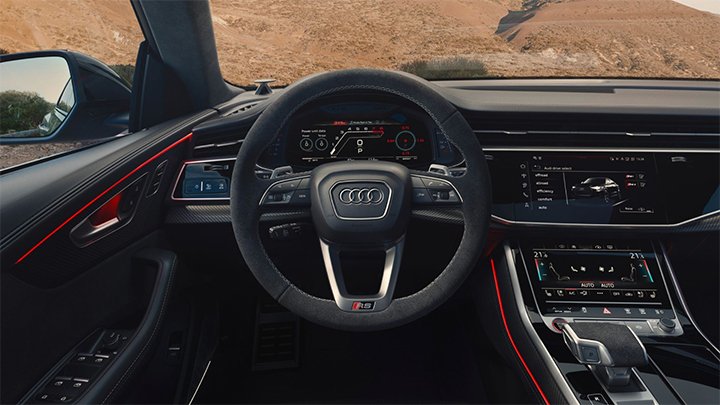 Cabin of an Audi RSQ8 where you can see the steering wheel and the infotainment system