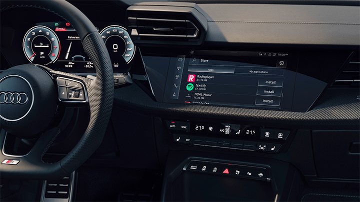Cabin of an Audi S8 where you can see the steering wheel and the infotainment system