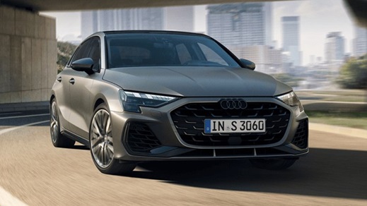 Grey S3 Sportback parked in a city with skyscrapers in the background
