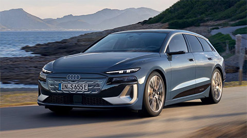 Blue Audi S6 Avant e-Tron parked in a mountain with the ocean in the background