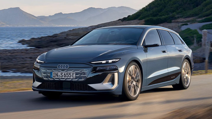 Blue Audi S6 Avant e-Tron parked in a mountain with the ocean in the background