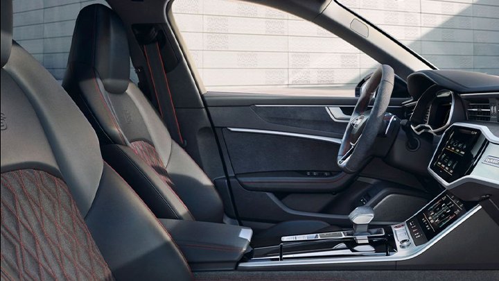 Interior of Audi S6 Avant showing the grey seats, gear, steering wheel and infotainment system on display